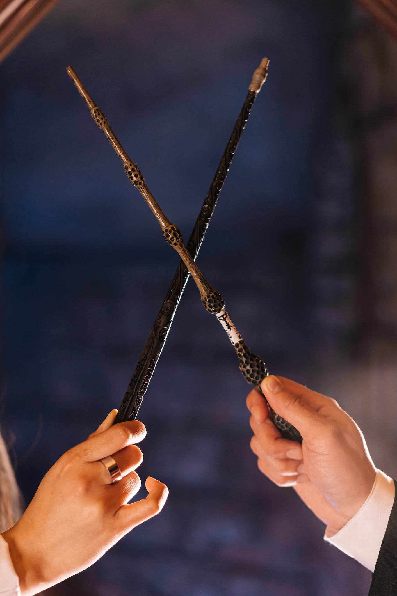 Two People Holding Magic Wands